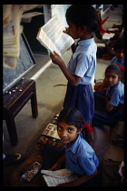 India, Rajasthan, Udaipur, Sisarma village school. Pupils reading in literacy class.