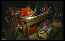 Mexico, Cuahuteolec, Yalambojoch. Guatemalan refugee girls writing at desks in village school.