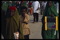 Somalia, Baidoa, Children walking to Dr Ayub Primary School carrying textbooks and abacus.