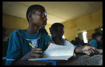 Uganda, Kampala, Schoolchildren working at desks in classroom at Mengo Primary School.