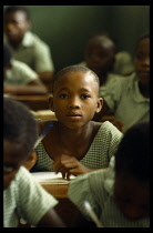 Nigeria, General, Schoolgirl looking up from desk in classroom.