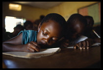 Uganda, Kampala, Children writing at desks in Mengo Primary School where 30% of the pupils are AIDS orphans.