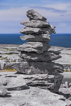 Ireland, County Clare, Rocky shoreline at Black Head with small stack of rocks constructed by tourists.
