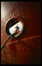 Environment, Scrap Metal, Boats, Lightship detail seen through anchor port of another ship at the Portsmouth Naval scrapyard.