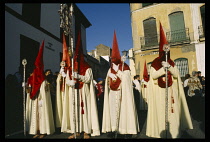 Spain, Andalucia, Seville, Semana Santa.  Penitents taking part in Easter procession.