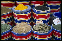 Egypt, Upper Egypt, Luxor, Display of herbs and spices in colourful striped sacks.