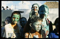 Belize, Ambergris Caye, San Pedro, Group of children covered in paint during carnival.