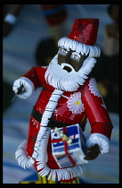 Mali, Bamako, Black toy Father Christmas made from insecticide spray tins.