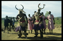 Sudan, Nuba Mountains, General, Kambala dancers dancers wearing head dresses decorated with bulls horns to denote strength.