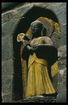 Nepal, Kathmandu, Patan, Statue of the Buddha in the entrance to Kwa Bahal or the Golden Temple.