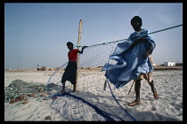 Mauritania, Fishing, Fishermen with nets on beach.