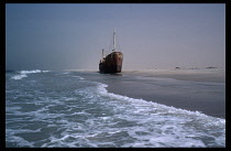 Mauritania, Transport, Wrecked ship on flat expanse of sandy beach.