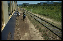 Congo, Transport, Train and rural stopping point with waiting passengers.