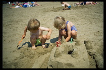 England, Somerset, Weston-Super-Mare, Children building sandcastles on the beach.