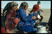 Mongolia, Gobi Desert, Women attired in their best clothes to attend haircutting ceremony which traditionally marks the point at which a child is considered to have survived infancy at 3-5 years For b...
