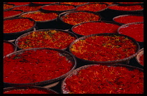 Vietnam, Food and Drink, Circular  shallow dishes of drying deep pink and yellow sweets.