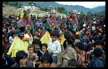 Bhutan, Religion, Festival to honour the mystic and teacher of Tibetan Buddhism Padmasabhava.  Crowds and dancers in costume.