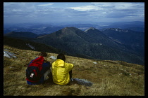 Slovakia, Carpathian Mts, Tatras Mountains, Walkers stopped to look at the view across the foothills of the Tatras Mountains.