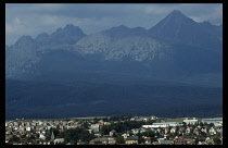 Slovakia, Carpathian Mts., Tatras Mountains, The High Tatras  distant peaks above town.