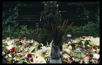 Indonesia, Bali, Batur, Offerings and incense in front of statue at Pura Ulun Danu Temple dedicated to Dewi Batari Ulun Dan  the goddess of lakes and rivers.