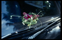 Indonesia, Bali, Religion, A daily offering for good business and protection on dashboard of taxi.