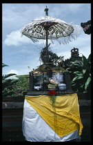 Indonesia, Bali, Sanur, Shrine with offerings for good business in front of factory.