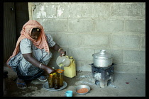 Sudan, Bur Sudan, Asetoriba Housing Project.  Ethiopian refugee making lemon drink.