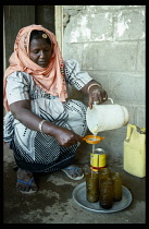 Sudan, Bur Sudan, Asetoriba Housing Project.  Ethiopian refugee making lemon drink.