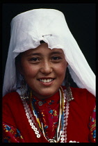 Afghanistan, Racial Traits, Children, Head and shoulders portrait of young Kirghiz girl wearing traditional costume.