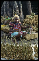 Papua New Guinea, Rabaul, Peanut vendor with genetic blonde hair.