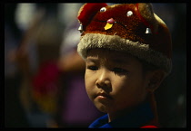 Thailand, Bangkok, Portrait of young boy wearing hat with animal face.