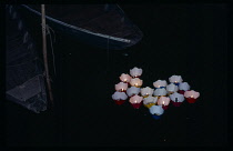 Vietnam , Central, Hoi An, Candles floating on river for the monthly Lunar Festival.