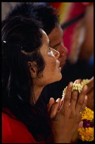 Thailand, South, Bangkok, Wat Meuang the City pillar the most important animist shrine in Bangkok with female devotee praying.