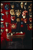 Italy, Veneto, Venice, Display of traditional Carnival masks in a sidestreet shop.