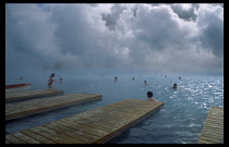 Iceland, Gullbringu, The Blue Lagoon, Swimmers in the water beside the thermal power station at Svartsengi.