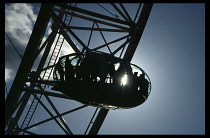 England, London, One capsule on the London Eye silhouetted against the sun.