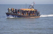 England, Kent, Dungeness, RNLI, helping migrants who have crossed the channel onto the beach.