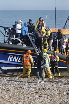 England, Kent, Dungeness, RNLI, helping migrants who have crossed the channel onto the beach.