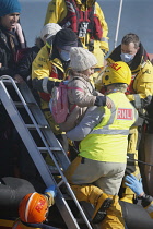 England, Kent, Dungeness, RNLI, helping migrants who have crossed the channel onto the beach.