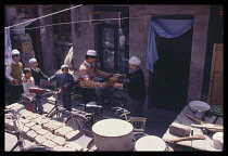 CHINA, Gansu Province, Lanzhou, Muslim family bringing food to celebrate the end of Ramadan.