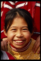 China, Guangzhou, People, Head and shoulders portrait of smiling girl.
