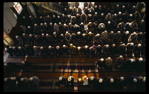 China, Gansu, Lanzhou, Mosque interior with prayers on festival day to mark the end of Ramadan.