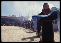 CHINA, Qinghai, Religion, Dancers carrying ceremonial scarves during Tibetan festival.