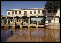 CHINA, Ningxia, Near Yinchuan, Water control station on the canal near the Yellow River with muddy water.