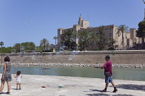 Spain, Balearic Islands, Majorca, Palma de Mallorca, Bubble blowing street performer outside the Royal Palace of La Almudaina.