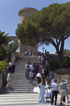 Spain, Balearic Islands, Majorca, Palma de Mallorca, Castle Bellver with wedding party taking photos on the steps.