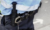 England, London, Trafalgar Square, Police liaison officer, light blue hi-vis, handcuffs.