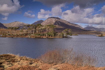Ireland, County Galway, Connemara, Derryclare Lough as seen from Pine Island Viewpoint with the Twelve Bens mountain range in the background.
