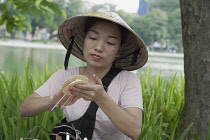 Vietnam, Hanoi, Street seller making a traditional Vietnamese sweet for sale.