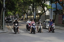 Vietnam, Hanoi, Mopeds waiting at a traffic intersection.